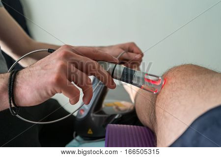 Laser Therapy On A Knee Used To Treat Pain