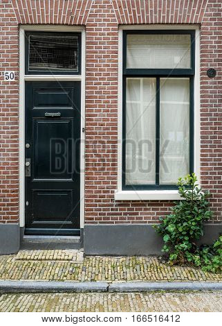 HAARLEM NETHERLANDS - 26 AUGUST 2014: A typical narrow house facade in a side street of Haarlem Netherlands.