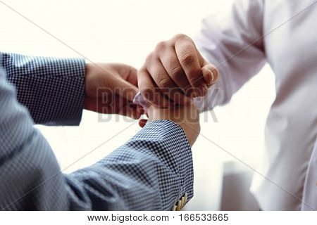 Stylish Bestman Helps Happy Elegant Groom Getting Dressed In The Morning For A Wedding