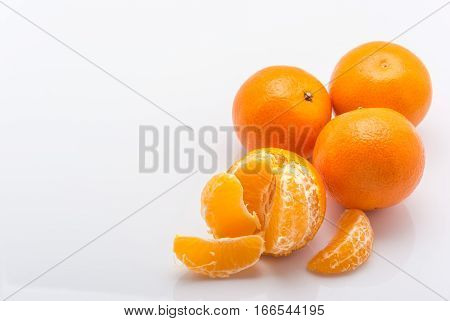 tangerines peeled tangerine and tangerine slices on a white background