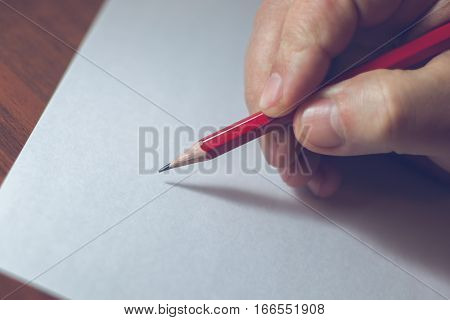 A Close Photo Of A Persons Writing A Letter With A Pencil