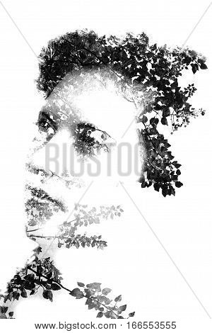 Double exposure of a young beautiful girl. Portrait of a female face. Picture isolated on white background. Female look. Abstract woman face and leaves black and white