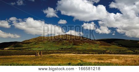 Machrie Moor standing stones on fields with mountains in background Isle of Arran Scotland