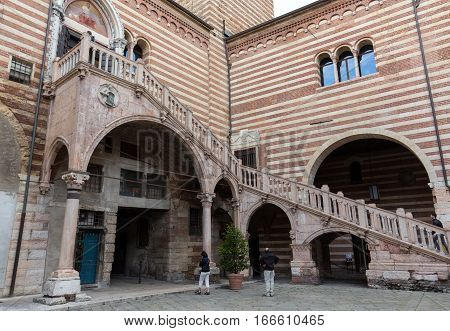 VERONA, ITALY - MAY 1, 2016: Scala della Ragione in the Courtyard of the Palazzo della Ragione in Verona. Italy