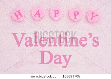 Old fashion Valentine's greeting Retro heart shaped candy on pick fabric with text Happy Valentine's Day
