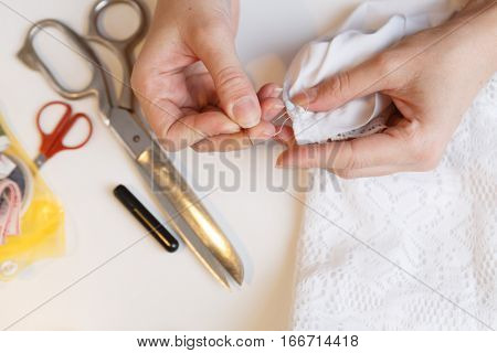 Girl unpick fabric on table