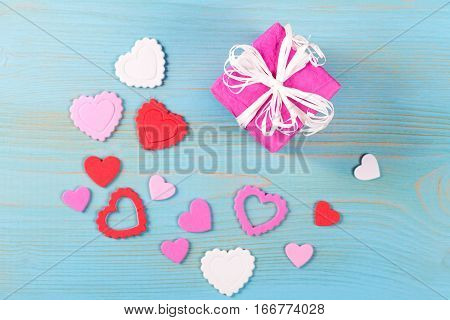 Background with gift boxes and hearts on white painted wooden planks. Place for text. Top view with copy space.