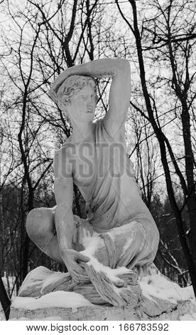 Moscow, Jan, 2017. Neskuchniy Garden. Gorky park. Sculpture of a girl in winter park covered with snow.