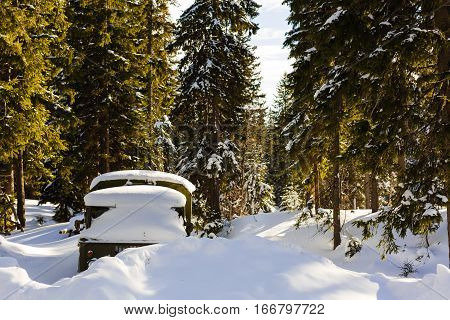 Car Covered With Snow In The Forest