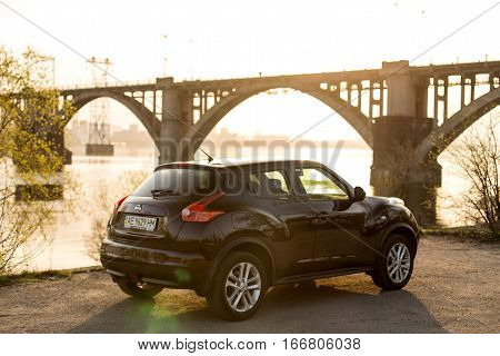 DNIPRO UKRAINE - APRIL 12 2016: NISSAN JUKE NEAR THE EMBANKMENT AT SUNSET
