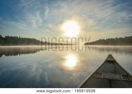 Canoe trip in the morning.  Brilliant and bright mid-summer sunshine morning, paddling a canoe in the middle of quiet, calm and peaceful Corry lake.
