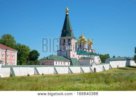 Belfry and cathedral of the Icon of the Mother of God Iverskaya in the sunny summer day. Iversky Svyatoozersky Bogoroditsky monastery. Valdai, Russia