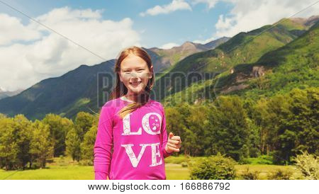 Cute little girl hiking in swiss Alps. Image taken in Simplon pass, border between Switzerland and Italy