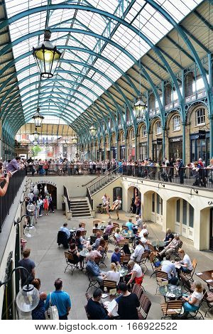 LONDON UK - MAY 19 2014: An audience watches a musical performance in Covent Garden Market