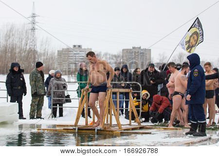 KAZAN, RUSSIA - JANUARY 19, 2017: Jesus Christ's baptism holiday on kazanka river. Traditional winter bathing in center of city, telephoto