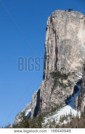 Mountain rocky fir wood forest and snow. Ortisei, Italy. Beautiful and winter mountain detail. Mountains of South Tyrol in northern Italy. Crust of rock, mountain summit. Rocky precipice. Ortisei, Italy