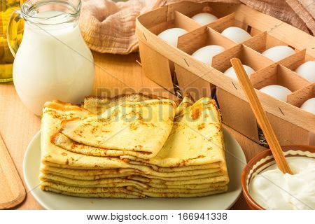 ingredients for making pancakes, pancakes on a wooden table