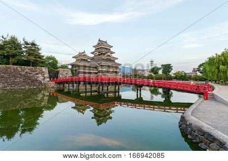 Matsumoto castle reflect on water in evening at nagano japan