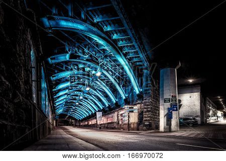 Illuminated steel construction of a railway bridge underpass