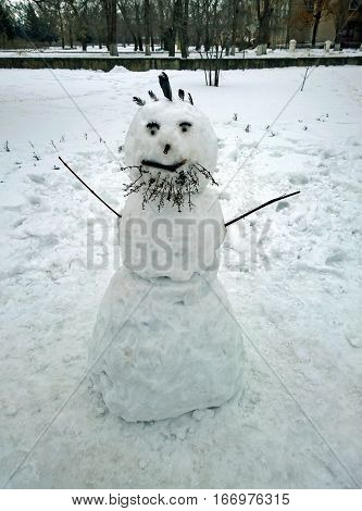 Funny snowman with a beard made by children in the city of Krivoy Rog in Ukraine