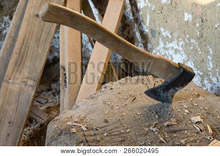 Old Ax Stabbed Into The Stump. Ax With Wooden Handle. Wood Processing