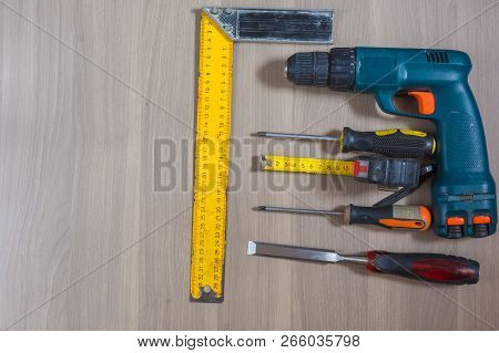 Different Tools On A Wooden Background. Hammer, Drill, Pliers. Screwdriver, Ruler, Cutting Pliers