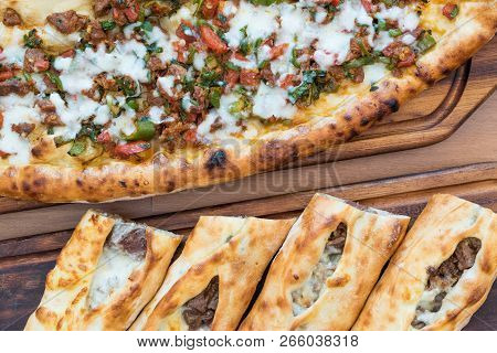 Turkish Bafra Pide With Minced Meat Kavurma Salad And Pickles.