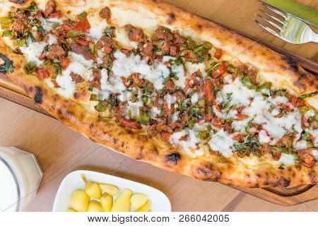 Turkish Pide With Minced Meat Kavurma Salad And Pickles.