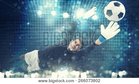 Close Up Of A Goalkeeper Dives To Save A Shot Aimed At The Goal With Light Effects