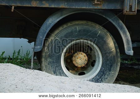 Stuck In The Sand Dirty Wheel Of A Truck. Close-up.