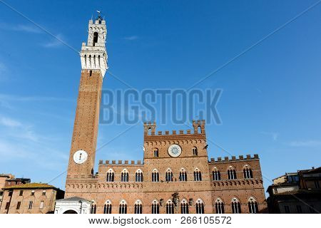 The Torre Del Mangia Is A Tower In Siena Next To The Palazzo Pubblico (city Hall), In The Tuscany Re