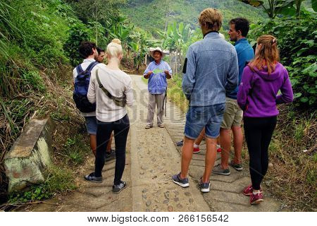 QUINDIO, COLOMBIA, 16 AUGUST, 2018 : Tourists taking part at a guided coffee tour in Quindio, Colombia, South America