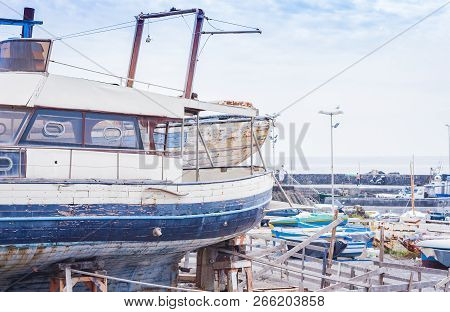 Acitrezza Harbor With Old Fisher Boat Next To Cyclops Islands, Catania, Sicily, Italy