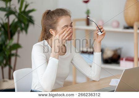 Tired Woman Having Eyestrain Sitting At The Desk In Office