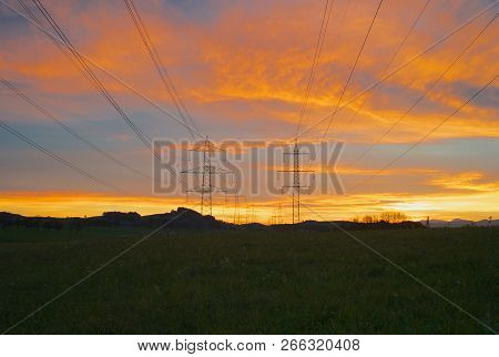 220 Kilovolt And 380 Kilovolt Electric Power Pylons At Dawn - 6 Phases And One Ground Wire