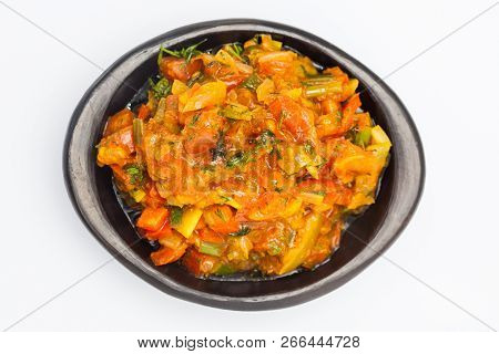 Traditional Colombian Sauce Called Hogao Served In A Black Ceramic Dish Isolated On White Background