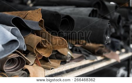 Different Pieces Of Leather In A Rolls. The Pieces Of The Colored Leathers. Rolls Of Natural Brown A