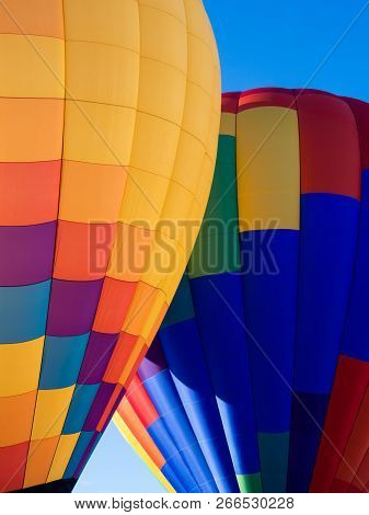 Two Colorful Hot Air Balloons On The Ground Ready To Take Off - At Winthrop Balloon Festival, Washin