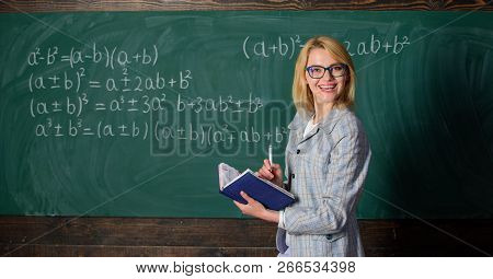 Effective Teaching Involve Acquiring Relevant Knowledge. Woman Teaching Near Chalkboard In Classroom