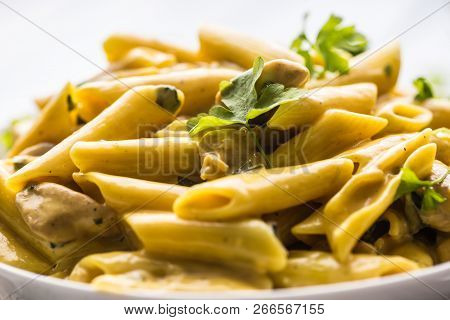 Pasta Pene With Chicken Pieces Mushrooms Parmesan Cheese Sauce And Herb Decoration. Pene Con Pollo -