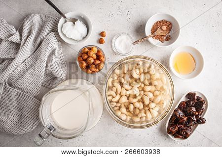 Ingredients For Raw Vegan Cake, Cashew Cake On A White Background, Flat Lay. Plant Based Dit Dessert