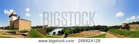 Panorama. Beautiful City Landscape. Medieaval Aged Castle And River. Blue Sky With Clouds