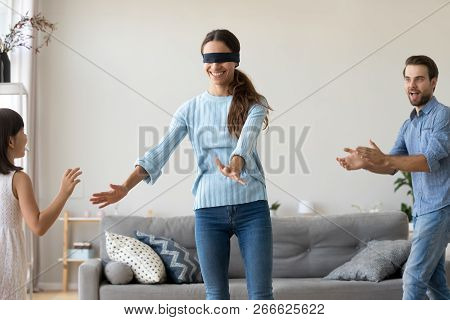 Family Playing Hide And Seek At Home