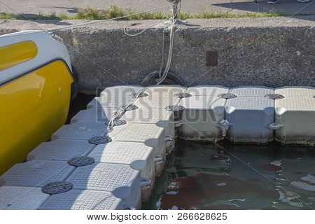 Plastic Pontoon Floating In The Lake Plastic Floating Dock. Plastic Pontoon Pier Leading To To Ancho