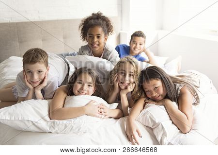 A Large Group Of Her Friends Taking Goog Time On Bed
