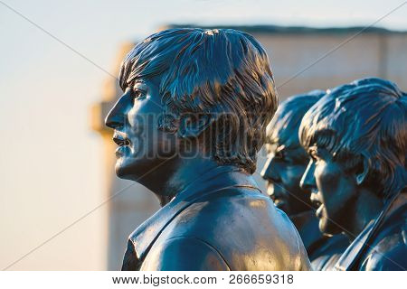 Liverpool, Uk - May 17 2018: Bronze Statue Of The  Beatles Stands At The Pier Head On The Side Of Ri
