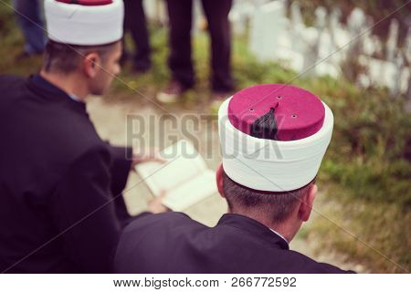 quran holy book reading by imam  on islamic funeral with white thumb stones graweyard background
