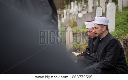 quran holy book reading by imam  on islamic funeral with white thumb stones graweyard background