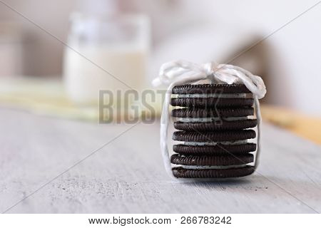 Delicious Chocolate Cookies Whit Vanilla Cream And Fresh Glass Of Milk In Background/ Conceptual Ima