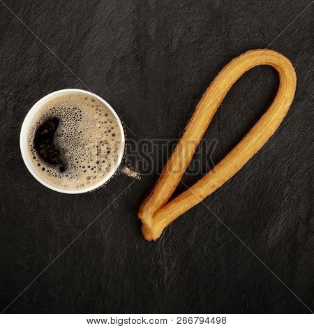 A Photo Of Black Coffee In A Vintage Cup And A Traditional Spanish Churro, A Typical Sunday Breakfas